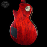 Red Gibson electric guitar on a black background with 'Tone Shop' logo.
