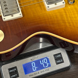 Guitar on a digital scale displaying weight