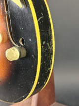 Close-up of a skateboard with a yellow wheel and black deck.
