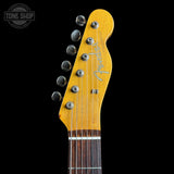 Guitar headstock with Fender logo on a black background