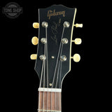 Gibson Les Paul guitar headstock with brand logo on a black background
