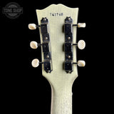 Guitar headstock with tuning pegs on a black background, featuring 'Tone Shop' logo.