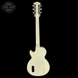 Back view of a white electric guitar on a black background with 'Tone Shop' logo.