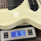 Guitar on a digital scale displaying weight