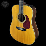 Acoustic guitar with a visible brand logo on a black background