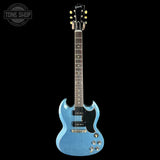 Blue electric guitar on a black background with 'Tone Shop' logo.