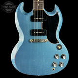 Blue electric guitar with a black pickguard on a dark background, featuring the 'Tone Shop' logo.