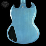 Back of a blue electric guitar with 'Tone Shop' logo in the corner.