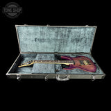 Guitar in an open case with 'Tone Shop' logo in the corner