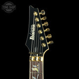 Guitar headstock with brand logo on a black background