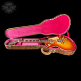 Gibson Les Paul guitar in a pink case with 'Tone Shop' logo.