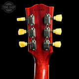 Close-up of a red guitar headstock with tuning pegs on a black background, featuring 'Tone Shop' branding.