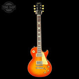 Orange electric guitar with a black background