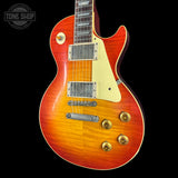 Electric guitar with a sunburst finish on a black background, featuring the Tone Shop logo.