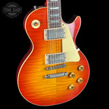 Electric guitar with a sunburst finish on a black background, featuring the Tone Shop logo.