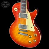 Electric guitar with a sunburst finish on a black background, featuring the Tone Shop logo.