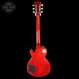 Red electric guitar on a black background with 'Tone Shop' logo.