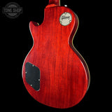 Red Gibson electric guitar body on a black background