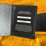 Gibson Custom Certificate of Authenticity for a Les Paul Custom guitar on a yellow background
