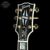 Gibson Les Paul Custom guitar headstock with brand logo on a black background