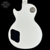 White electric guitar body with Gibson logo on a black background