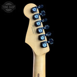 Guitar headstock with tuning pegs on a black background, featuring 'Tone Shop' logo.