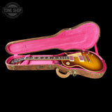 Gibson Les Paul guitar in a pink case with 'Tone Shop' logo.
