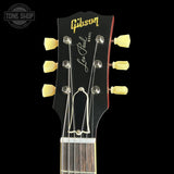 Gibson Les Paul guitar headstock with brand logo on a black background