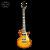 Electric guitar with a sunburst finish on a black background, featuring the Gibson logo.