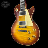 Electric guitar with a sunburst finish on a black background, featuring the Tone Shop logo.