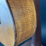 Close-up of a wooden guitar's soundhole with a blurred background