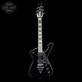 A black electric guitar with chrome hardware, displayed vertically against a solid black background. A 'TONE SHOP' watermark is visible in the top-left corner.
