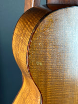 Close-up of a wooden guitar's soundhole and neck