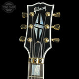 Gibson guitar headstock with brand logo on a black background