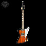 Electric guitar with a sunburst finish on a black background, featuring the Tone Shop logo.