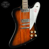 Gibson electric guitar with a sunburst finish on a black background, featuring the Tone Shop logo.