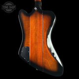 Guitar body with wavy design on a black background, featuring 'Tone Shop' logo.
