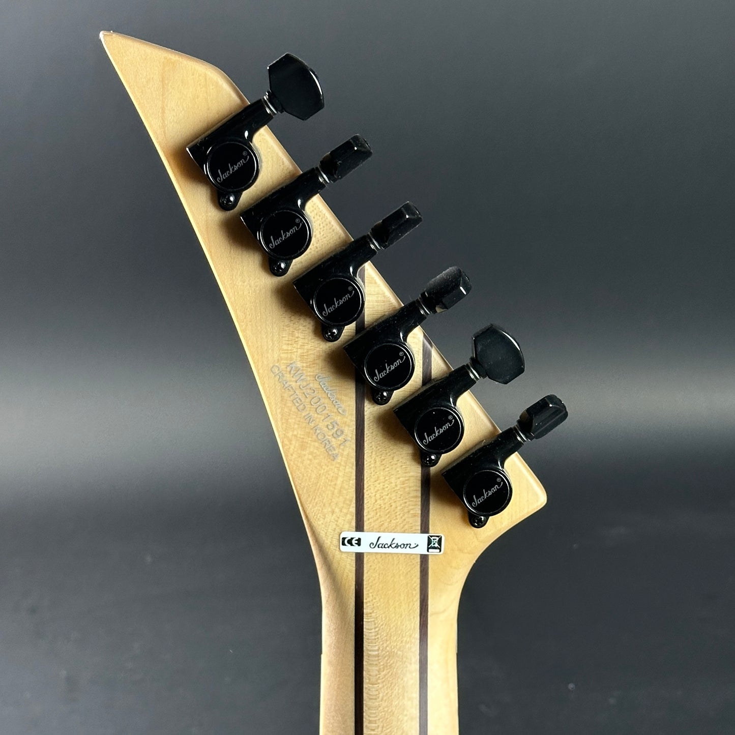 Back of headstock of Used Jackson Ltd Wildcard Series Soloist SL2P Transparent Black Burst.