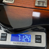 Wooden briefcase on a digital scale displaying weight