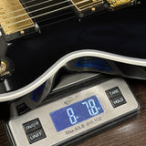 Guitar on a digital scale displaying weight