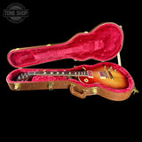Gibson Les Paul guitar in a red-lined case with 'Tone Shop' logo.