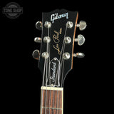 Gibson Les Paul guitar headstock with brand logo on a black background