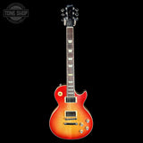 Electric guitar with a sunburst finish on a black background, featuring the Tone Shop logo.