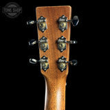 Close-up of a guitar headstock with tuning pegs on a black background, featuring the Tone Shop logo.
