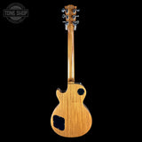Wooden electric guitar on a black background with 'Tone Shop' logo.