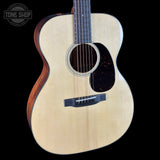 Acoustic guitar with a visible brand logo on a black background