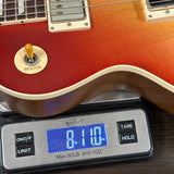Guitar on a digital scale displaying weight