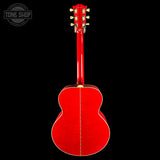 The back of a glossy red acoustic guitar, showing the sound hole, body wood grain, and headstock against a solid black background. A 'TONE SHOP' watermark is visible in the top left corner.