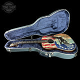 Acoustic guitar with American flag design in a blue case, Tone Shop logo visible.