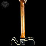 Close-up of the neck and lower body of a Fender electric guitar with a black body, cream trim, and a glossy flamed maple wood neck, shown against a black background.